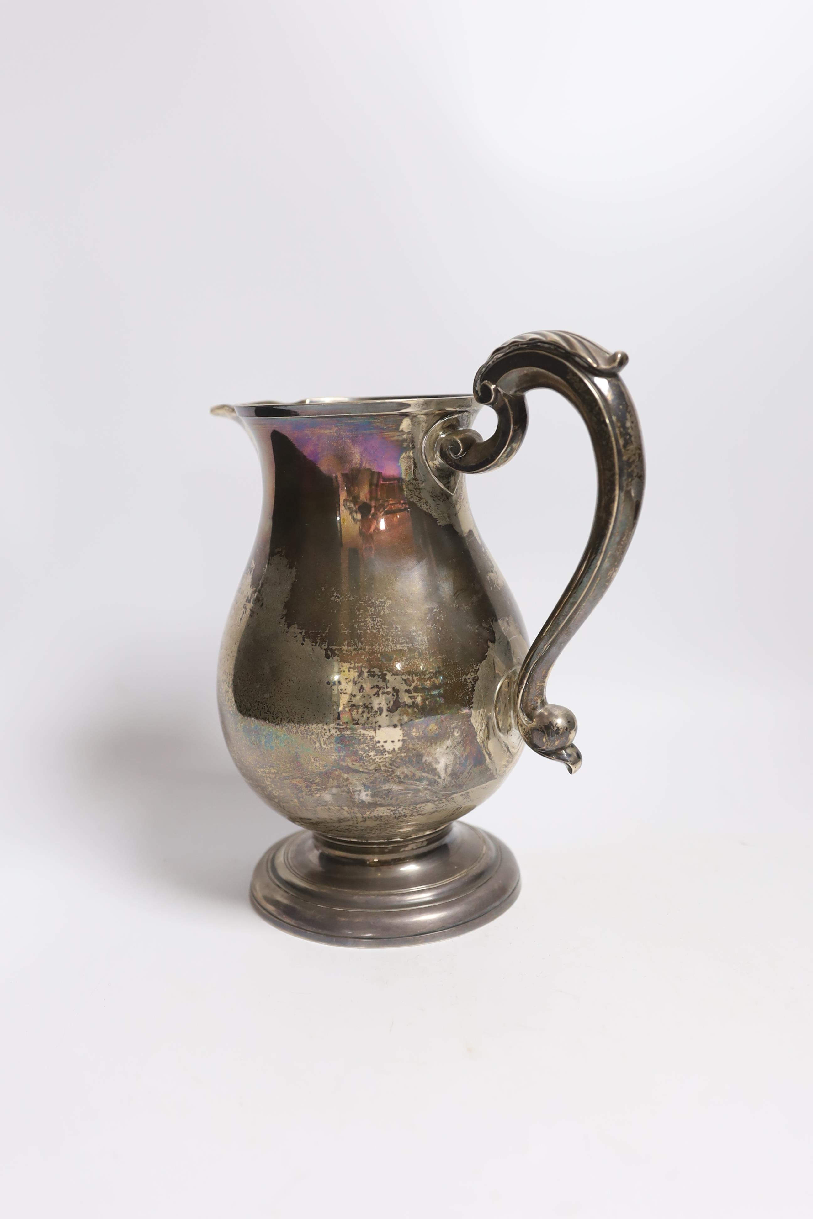 A George II silver baluster ale jug, on pedestal foot, Henry Brind, London, 1744, height 23.5cm, 33oz.